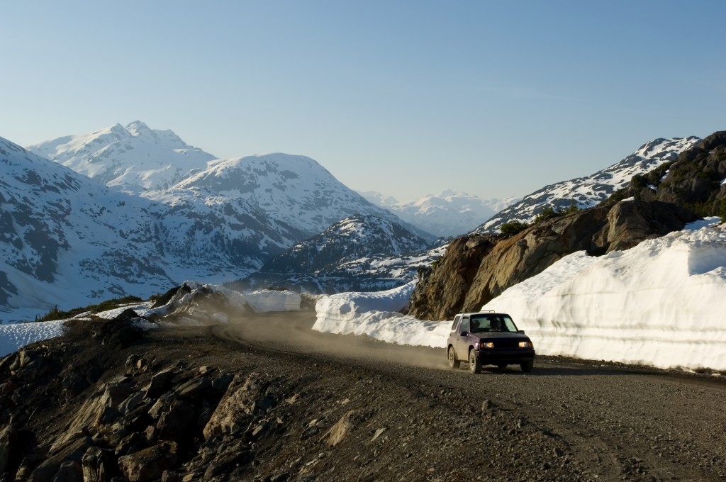 car-driving-on-gravel-road-in-alaska